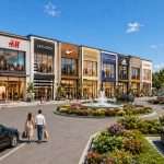 Front elevation of a modern commercial building with retail shops and offices